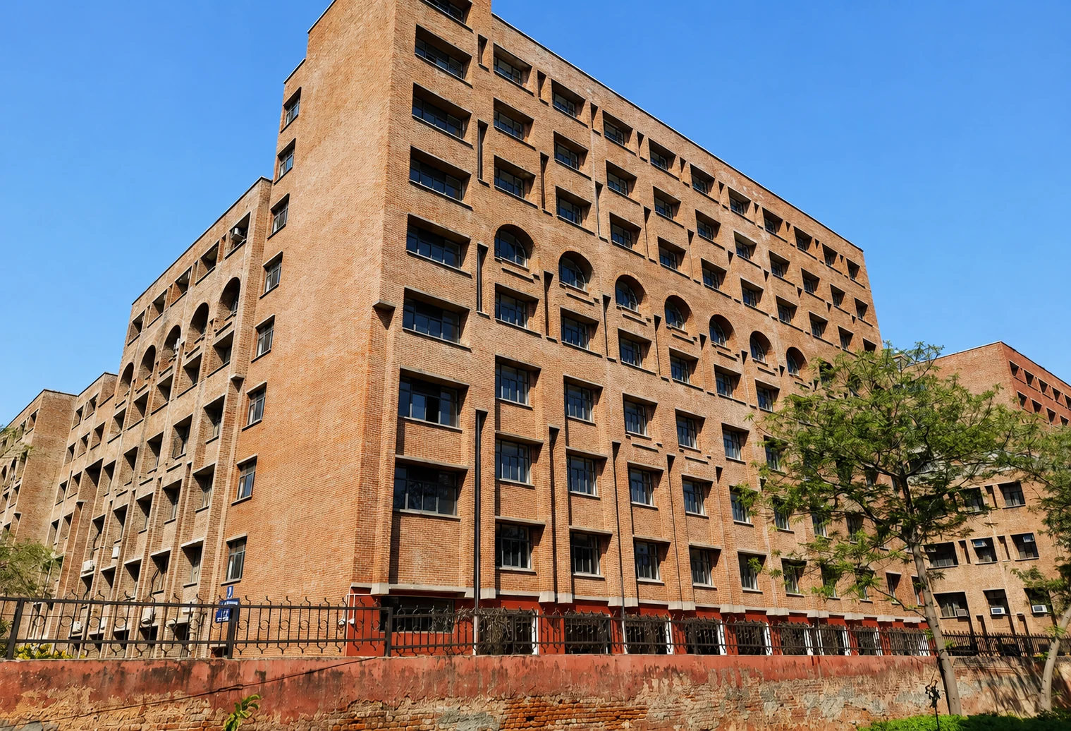 Red brick academic building constructed by Shreeji Constructions